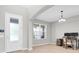 Bright living room featuring wood floors, a large window and a stylish desk area at 4496 Tatum Loop, Odessa, FL 33556