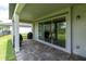 Covered outdoor patio with durable pavers and a large sliding glass door that invites you outside at 4496 Tatum Loop, Odessa, FL 33556
