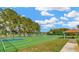 Community basketball court with benches, ample space to play, and is lined by mature trees for shade at 4535 Gateway Blvd, Wesley Chapel, FL 33544