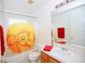 A clean bathroom with a tub and shower combination and a yellow flower patterned shower curtain at 4535 Gateway Blvd, Wesley Chapel, FL 33544