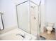 Clean bathroom showcasing a glass-enclosed shower, soaking tub with chrome hardware, and toilet at 4535 Gateway Blvd, Wesley Chapel, FL 33544