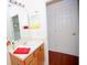 Bright bathroom featuring a wood vanity, white sink, and a large mirror at 4535 Gateway Blvd, Wesley Chapel, FL 33544