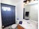 Well-maintained bathroom with a large vanity mirror, single sink, toilet, and tub shower with curtain at 4535 Gateway Blvd, Wesley Chapel, FL 33544