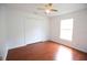 Bedroom with wood flooring, ceiling fan and natural light from the window at 4535 Gateway Blvd, Wesley Chapel, FL 33544
