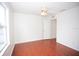 This bedroom features wood floors and a ceiling fan at 4535 Gateway Blvd, Wesley Chapel, FL 33544