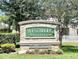 Stone community sign surrounded by lush landscaping and mature trees providing a welcoming entrance at 4535 Gateway Blvd, Wesley Chapel, FL 33544