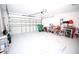 Spacious two car garage with an automatic door and clean epoxy flooring offering ample space at 4535 Gateway Blvd, Wesley Chapel, FL 33544