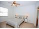 Main bedroom with decorative bedside tables, ceiling fan, and tiled flooring at 4535 Gateway Blvd, Wesley Chapel, FL 33544