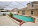 Backyard swimming pool with a screened-in patio and outdoor seating at 4535 Gateway Blvd, Wesley Chapel, FL 33544