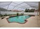 Backyard pool and hot tub with screened in patio and outdoor seating area at 4535 Gateway Blvd, Wesley Chapel, FL 33544