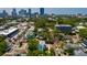 Aerial view of a home with gray metal roof, in a neighborhood surrounded by lush trees at 457 8Th N Ave, St Petersburg, FL 33701