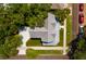Aerial view of a home with gray metal roof, green lawn, and mature landscaping at 457 8Th N Ave, St Petersburg, FL 33701