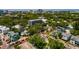 Aerial view of a home with gray metal roof, in a neighborhood surrounded by lush trees at 457 8Th N Ave, St Petersburg, FL 33701