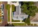 Aerial view of a home with gray metal roof, green lawn, and mature landscaping at 457 8Th N Ave, St Petersburg, FL 33701