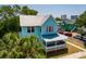 Light blue two-story house with metal roof and front porch at 457 8Th N Ave, St Petersburg, FL 33701