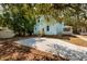Backyard view of the house with a parking area and some trees at 457 8Th N Ave, St Petersburg, FL 33701