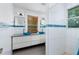 Bright bathroom featuring double sinks, granite countertops, and white tiled walls at 457 8Th N Ave, St Petersburg, FL 33701