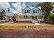 Charming two-story home with a wraparound porch and light blue painted wood facade at 457 8Th N Ave, St Petersburg, FL 33701