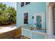 Exterior angle view of a light blue house with a light colored stair and wooden rails at 457 8Th N Ave, St Petersburg, FL 33701