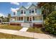 Charming light blue two-story home with a large porch and well-manicured lawn at 457 8Th N Ave, St Petersburg, FL 33701