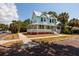 Charming two-story home with a wraparound porch and light blue painted wood facade at 457 8Th N Ave, St Petersburg, FL 33701
