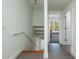 Hallway with modern stairwell, leading to a living area with natural light, seamlessly connecting spaces at 457 8Th N Ave, St Petersburg, FL 33701