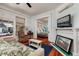 Cozy living room flows into the bedroom, enhanced by ample natural light and a comfortable recliner at 457 8Th N Ave, St Petersburg, FL 33701