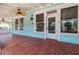 Spacious front porch featuring wood flooring, ceiling fans, and ample natural light at 457 8Th N Ave, St Petersburg, FL 33701