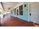 Inviting front porch with wood flooring, ceiling fans, and classic architectural details at 457 8Th N Ave, St Petersburg, FL 33701