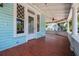 Inviting porch with decorative windows, painted in light blue with wooden floor at 457 8Th N Ave, St Petersburg, FL 33701