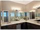Bathroom featuring double sinks, granite countertops, and a separate shower and bathtub at 4830 Grand Banks Dr, Wimauma, FL 33598