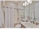 Clean bathroom with white tiled shower and tub, updated vanity and fixtures at 4830 Grand Banks Dr, Wimauma, FL 33598