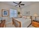 Cozy bedroom with warm lighting, ceiling fan, and classic furniture at 4830 Grand Banks Dr, Wimauma, FL 33598