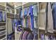 Organized walk-in closet with shelving and hanging rods for optimal storage and organization at 4830 Grand Banks Dr, Wimauma, FL 33598