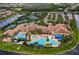 Aerial view of clubhouse amenities featuring pools, tennis courts, and ample parking at 4830 Grand Banks Dr, Wimauma, FL 33598