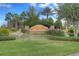 Valencia Lakes entrance showcasing a lush water feature, beautiful landscaping and stone signage at 4830 Grand Banks Dr, Wimauma, FL 33598