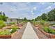 Community garden with multiple raised garden beds, gravel pathways and a garden shed at 4830 Grand Banks Dr, Wimauma, FL 33598