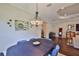 Spacious dining room includes a dark wood table, decorative chandelier, and an open floor plan at 4830 Grand Banks Dr, Wimauma, FL 33598