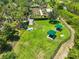 Aerial view of dog park with green grass, shade canopies, and fenced perimeter at 4830 Grand Banks Dr, Wimauma, FL 33598