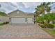 Beautiful home with a three car garage and a brick paved driveway at 4830 Grand Banks Dr, Wimauma, FL 33598