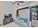 Versatile room featuring a sleek Murphy bed and custom shelving for flexible living at 4830 Grand Banks Dr, Wimauma, FL 33598