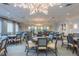 Elegant game room featuring a large chandelier, multiple game tables and neutral walls at 4830 Grand Banks Dr, Wimauma, FL 33598