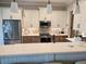 Well-equipped kitchen featuring stainless steel appliances, quartz countertops, and ample cabinet space at 4830 Grand Banks Dr, Wimauma, FL 33598
