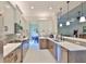 Modern kitchen features stainless appliances, breakfast bar, with view into dining and living spaces at 4830 Grand Banks Dr, Wimauma, FL 33598