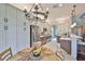 Bright kitchen featuring modern appliances, stainless steel refrigerator, stylish lighting, and breakfast bar at 4830 Grand Banks Dr, Wimauma, FL 33598