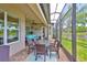 Covered and screened lanai features outdoor seating, a dining area, and beautiful lake views at 4830 Grand Banks Dr, Wimauma, FL 33598