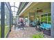 Spacious screened lanai with comfortable seating and dining area, overlooking scenic views at 4830 Grand Banks Dr, Wimauma, FL 33598
