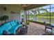 Inviting screened lanai with comfortable seating area and beautiful lake view at 4830 Grand Banks Dr, Wimauma, FL 33598