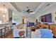 Open concept living room with hardwood floors, a ceiling fan, and a view of the kitchen at 4830 Grand Banks Dr, Wimauma, FL 33598