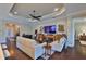 Spacious living room featuring a decorative tray ceiling, hardwood floors and comfortable seating at 4830 Grand Banks Dr, Wimauma, FL 33598